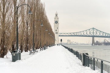 St. Lawrence River with Clock tower in Old Montreal, in winter.
