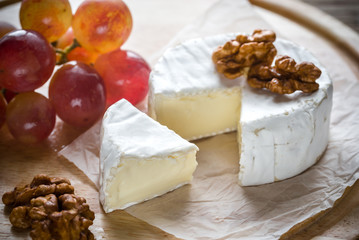 Camembert cheese with walnuts and grape