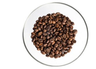Roasted coffee beans on a glass transparent saucer, isolated on white background...