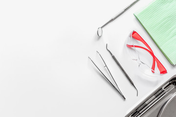 dentists tools in cabinet on white desktop