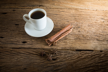 coffee cup, cinnamon sticks on wooden table