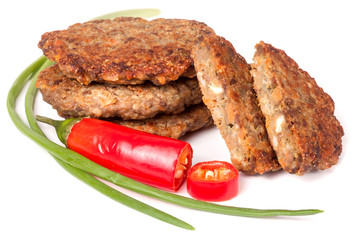 liver pancakes or cutlets with chili pepper and green onions isolated on white background