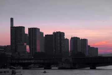 Cityscape with buildings, bridge, river and red sunset sky. Selective focus. Copy space, Toned image. Selective focus.