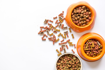 dry dog food in bowl on white background top view