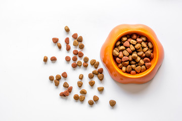 dry pet food in bowl on white background top view