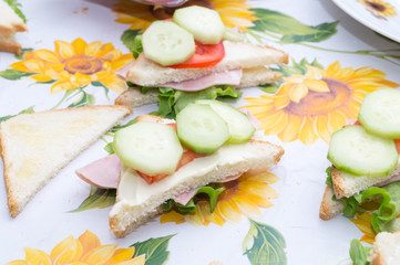 sandwiches with ham and tomato salad