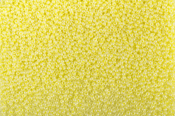Yellow glass beads background - closeup beads texture