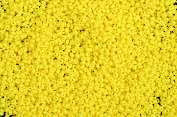 Yellow glass beads background - closeup beads texture