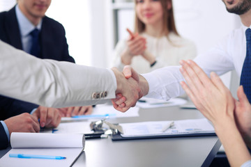 Close up of  two business man shaking hands to each other finishing up the meeting