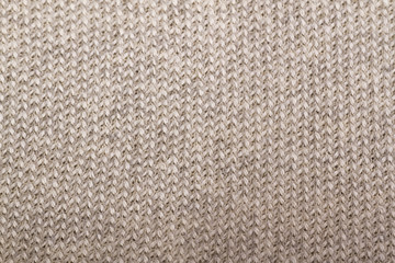 Fototapeta na wymiar beige knitted fabric textured background