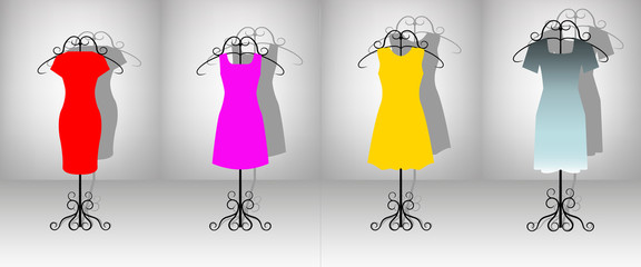 Set of four color female dresses on hanger.