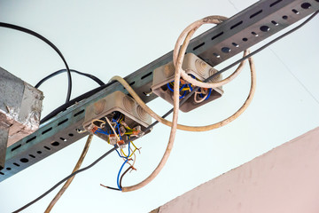 Electrical wiring with exposed wires. Code violation. - obrazy, fototapety, plakaty