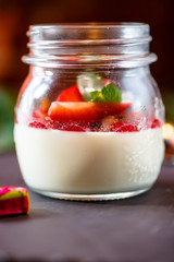 Dessert. Yogurt with strawberries in a jar.