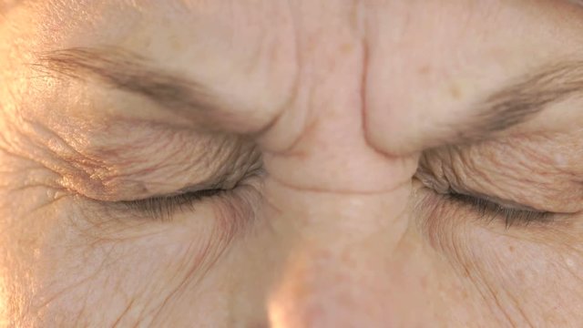 Old woman's face with tired expression of face. Close up