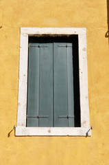 venetian window with closed wooden shutters