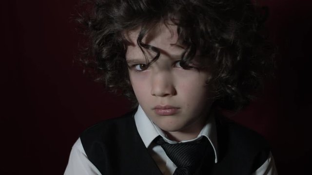 4k Shot of a Cute Businessman Child Turning his Eyes to Camera