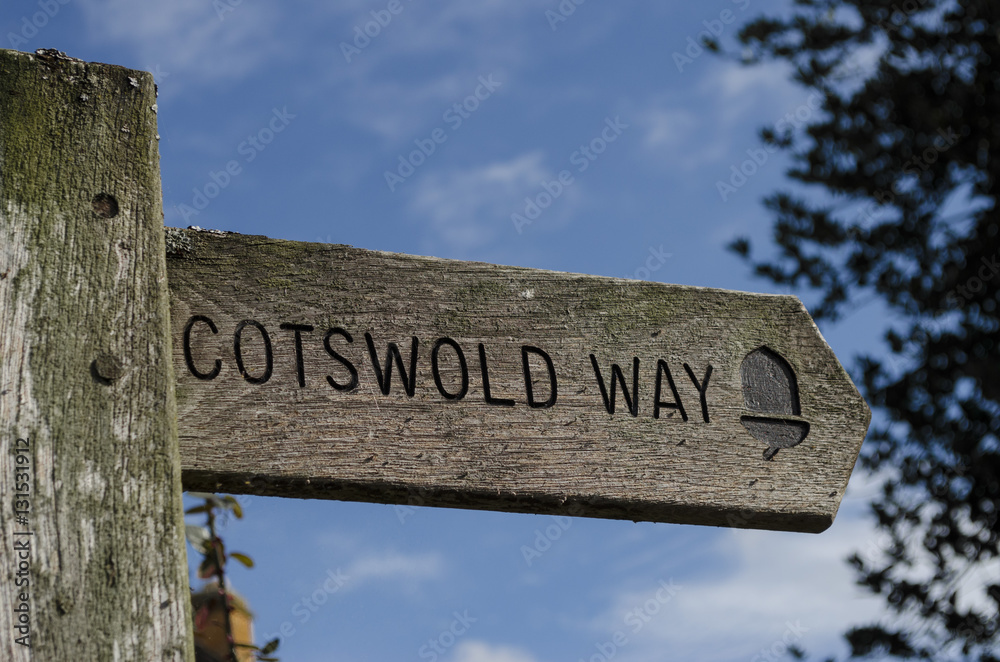 Wall mural Wooden signpost pointing the direction of the Cotswold Way footpath