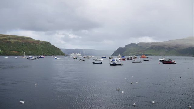 Timelapse of several boats at Portree harbour, Portree town, Isle of Skye, Scotland, United Kingdom. (4K Timelapse)
