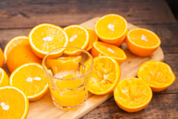 juice and oranges on a rustic background, selective focus