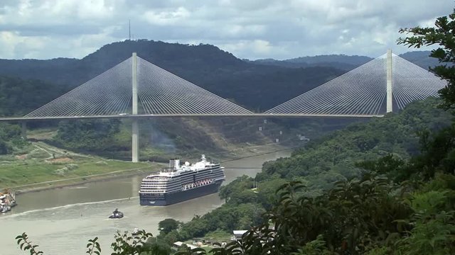 Cruise ship sailing under Panama Bridge