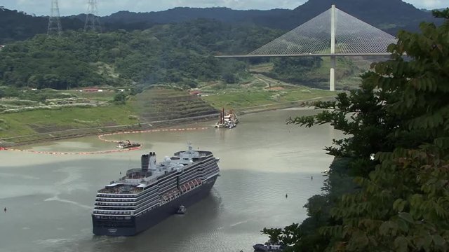 Cruise ship sailing under Panama Bridge