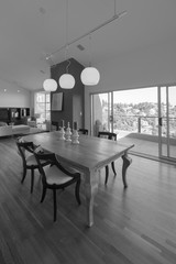Elegant dining table and chair with open sliding doors leading t