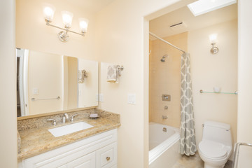 Fototapeta na wymiar Stylish Bathroom interior in beige with bathtub