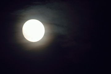 Background Shining full moon in black night sky