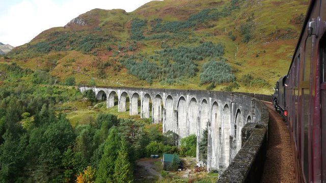 Glenfinnan Railway Viaduct in Scotland with the Jacobite steam train in Scotland, UK
