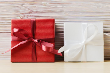 Red and white gift boxes against wooden background