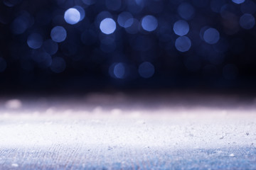 Holiday background with snow on wooden plank over abstract bokeh