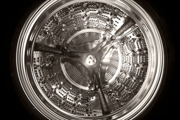 Inner drum of a washing machine. Stainless steel. Close up image. Fish eye shot. Black and white image.