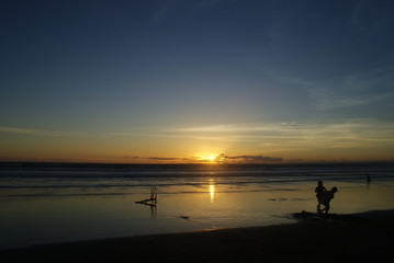 Silhouetted Couple at Sunset on Tranquil Beach