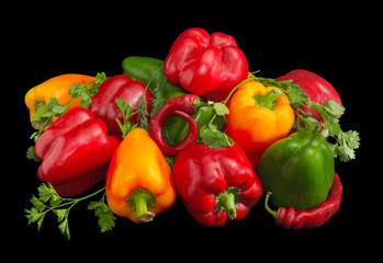 Several green, yellow and red bell peppers, chili and greens