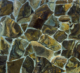 Fototapeta premium Wall made of black rough stone close-up
