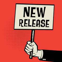Poster in hand, business concept with text New Release