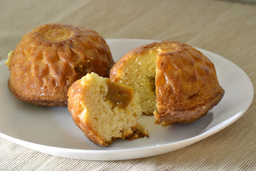 Two muffin on a white plate with a stuffing