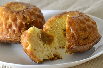 Two muffin on a white plate with a stuffing