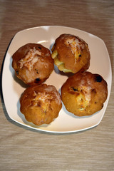 Muffins on plate with selective focus on nearest muffin.