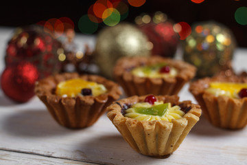 Homemade desserts with fruits for the new year. Desserts for the holidays. Side view. Against dereeva and trees. Beautiful background.