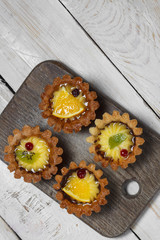 Homemade desserts with fruits for the new year. Desserts for the holidays. Side and top view. On a wooden background