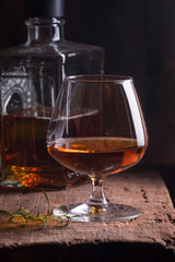 Glass of brandy or cognac and bottle