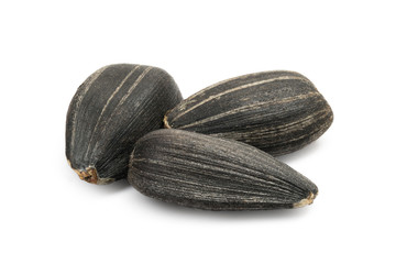 Macro photo of three black sunflower seeds isolated on white with large DOF