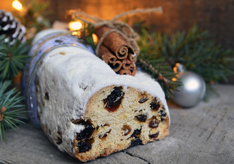 Christmas stollen with marzipan, berries and cinnamon.Traditional German festive baking.Stollen Christmas cake.Soft selective focus.Copy space.