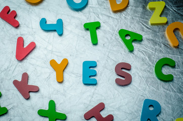 YES word with colourful alphabet blocks made of wooden. Business