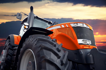 Tractor on a background cloudy sky