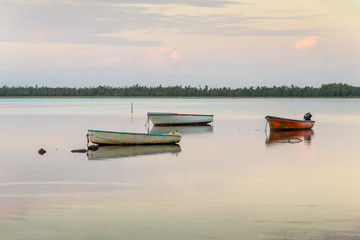 Rustic fishing boats at sunrise. Mauritius island scenery.