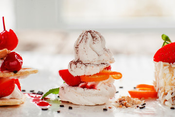 Creamy tasty sweet dessert close-up, free space. Variety of tasty pastries with fresh berries. Confectionery, restaurant bakery, delicatessen concept