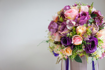 Bright purple flowers in a white vase.