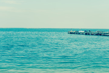 Fototapeta premium Fishing pier jutting into the blue sea.